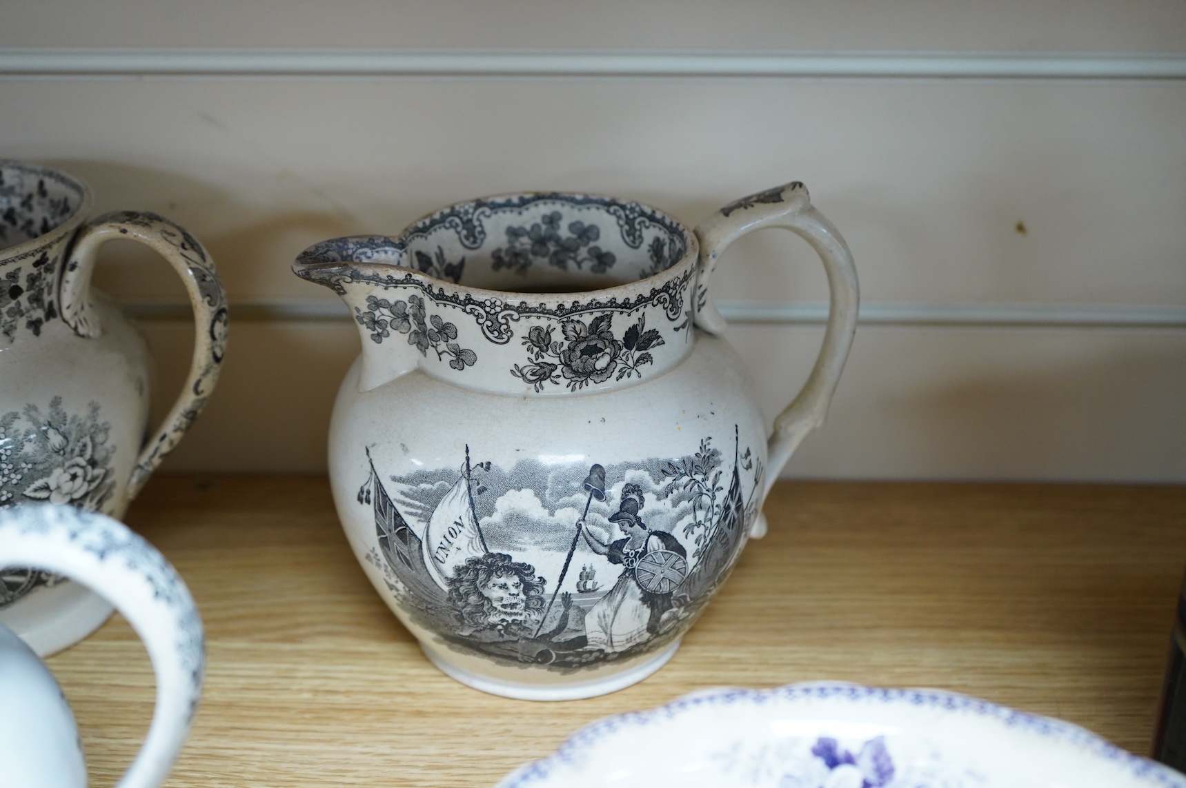 Six contemporary political themed earthenware pottery jugs and a pedestal bowl commemorating the 1832 Reform Bill, with transfer printed symbolic scenes of the Houses of Parliament, details regarding the voting, portrait